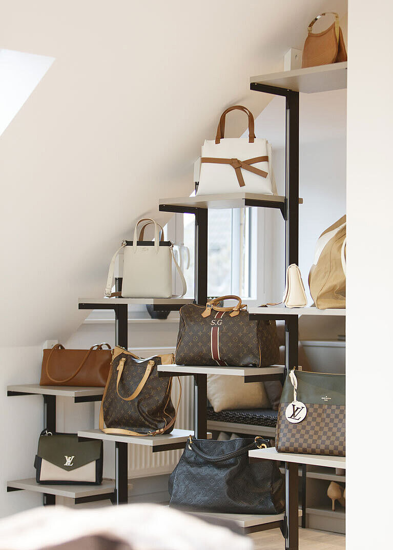 Die Dachschräge wurde mit einem offenen Regal verbaut, das Platz für Handtaschen bietet
